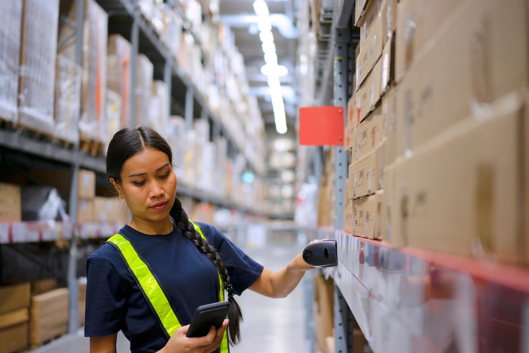 Employee checking merchandise in warehouse